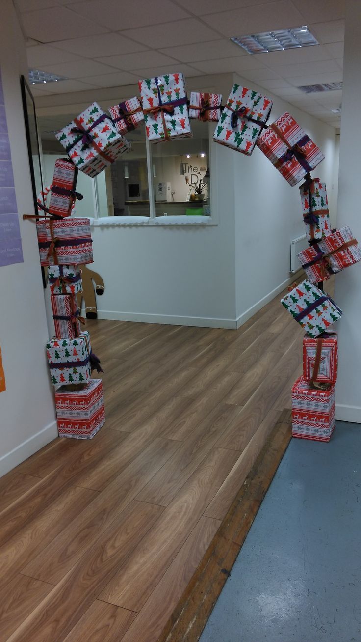 there are many boxes stacked on top of each other in an office space with wood floors