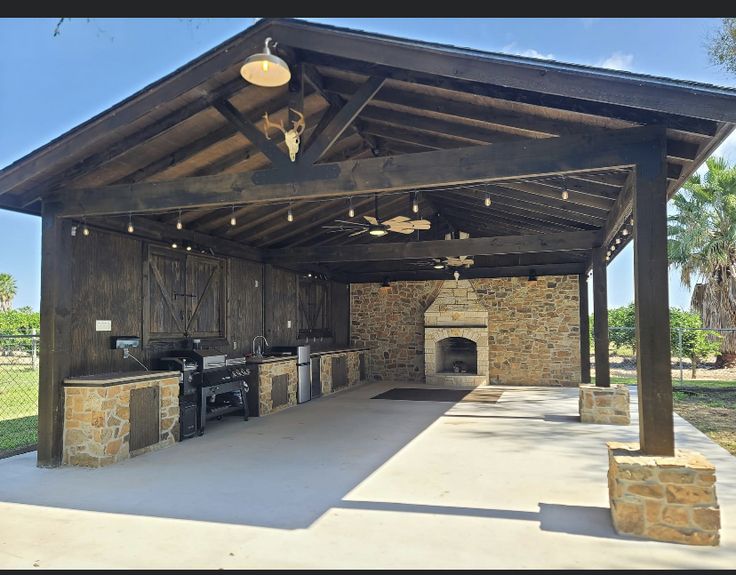 an outdoor bbq with grills and seating