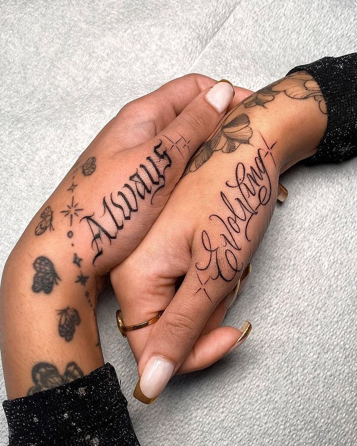 two people holding hands with tattoos on their arms and the words always love are written in cursive writing