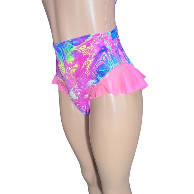 Introducing our Rave Bikini Bottom with Mesh Ruffle, the ultimate blend of sass and style for the dance floor diva in you! These hot pants are designed to make a statement with their high-thigh cut and super cheeky design, guaranteed to turn heads and set the dance floor on fire. The highlight of these hot pants is the mesh ruffle detailing on the sides, adding a touch of flirtatious flair and playful movement to your outfit. Whether you're grooving to the beat at a rave, hitting the club scene, Trendy High Waist Bottoms For Festivals, Fitted Disco Swimwear For Club, Disco Style Fitted Swimwear For Club, High Waist Bottoms For Club And Summer, High Waist Summer Club Bottoms, High Waist Fitted Bottoms For Festival, Pink High-cut Leg Bottoms For Summer, High Waist Dancewear Bottoms For Summer, Hip-length Bottoms For Summer Club Wear