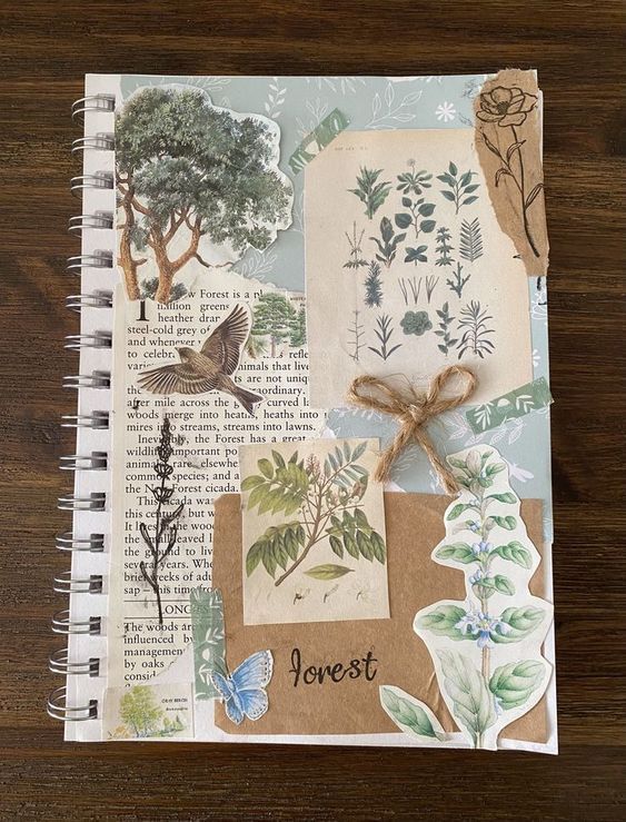 an open notebook with paper and stickers on the pages, featuring trees, leaves, birds and flowers