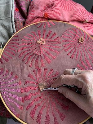 a person is working on an embroidery project