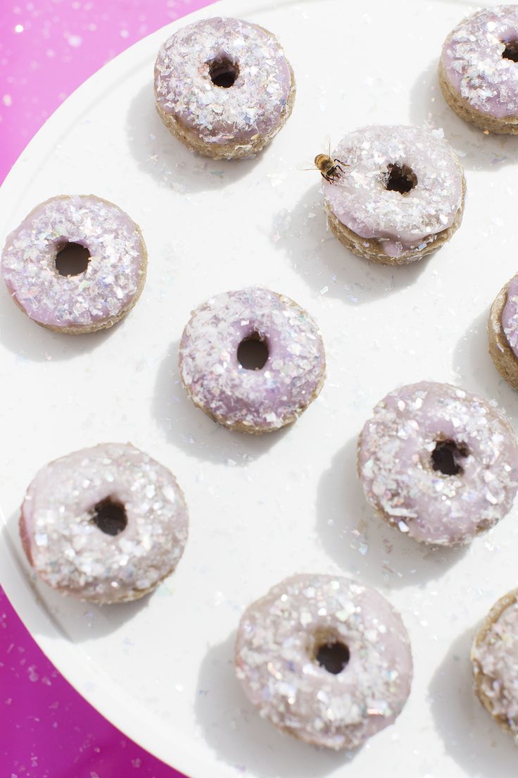 there are many doughnuts on the plate with sprinkles around them