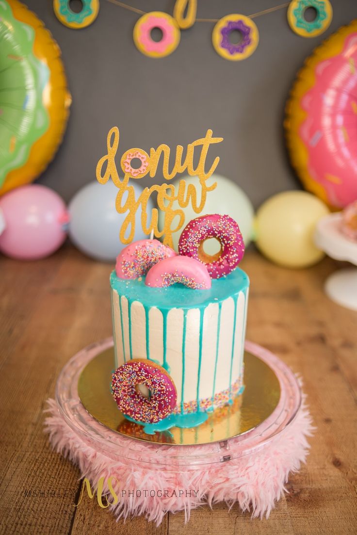 a birthday cake with donuts and sprinkles on it