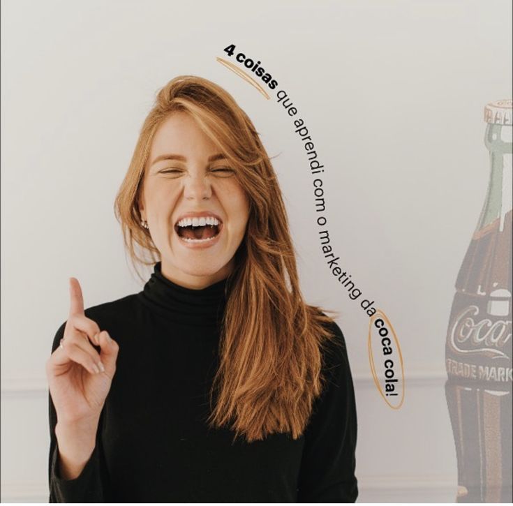 a woman is laughing and holding her finger up in front of a coca cola bottle