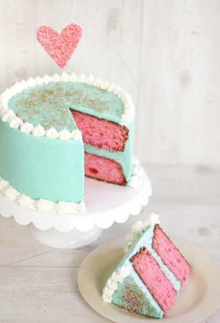 a pink and blue cake sitting on top of a white plate