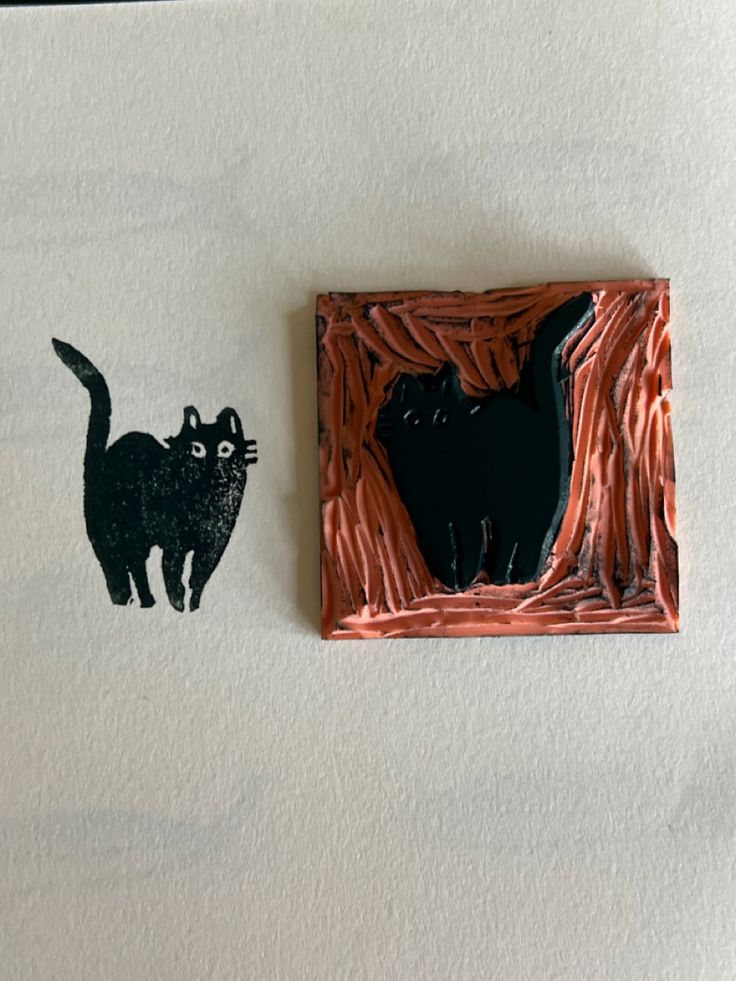 a black cat standing in front of a piece of paper that is cut into the shape of a tree