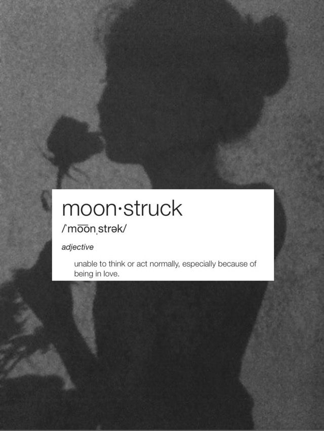 a black and white photo of a woman holding a rose in her hand with the words moon - struck above it