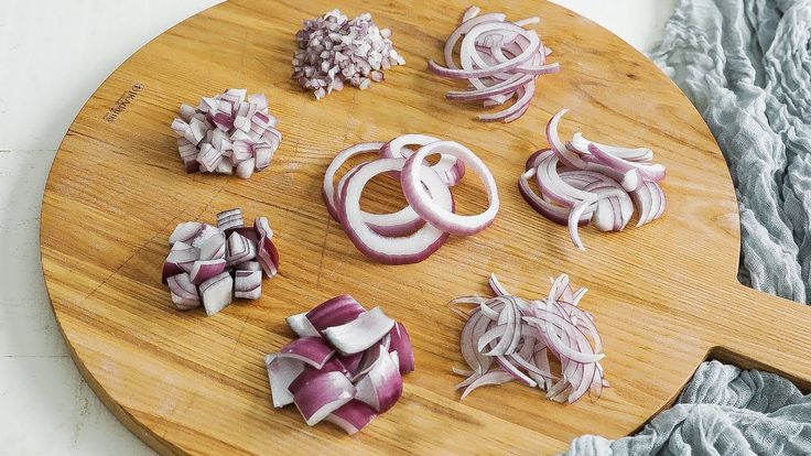 chopped onions on a wooden cutting board ready to be cooked