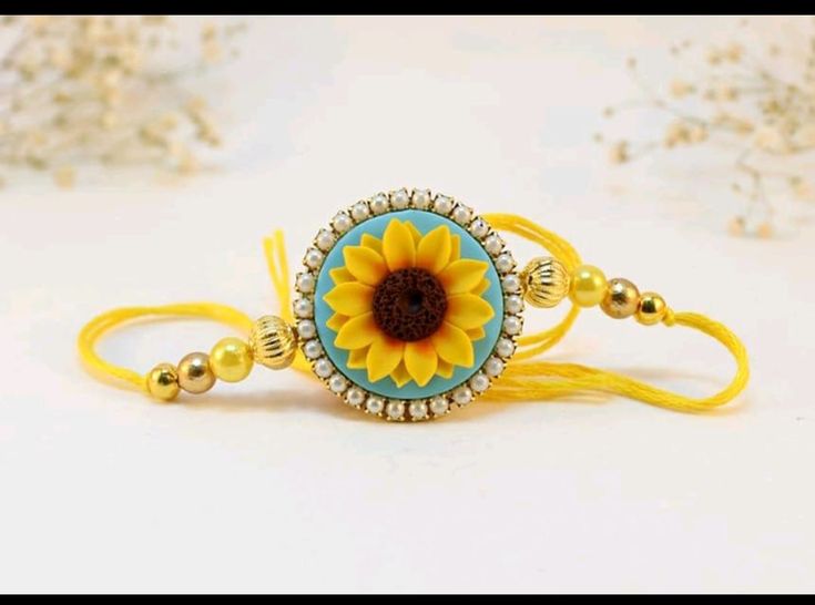 a yellow and blue bracelet with a sunflower on the front, beaded around it