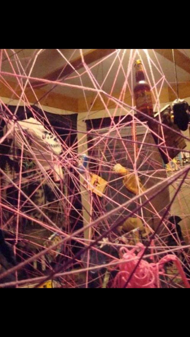 pink yarn is tangled up in the middle of a room