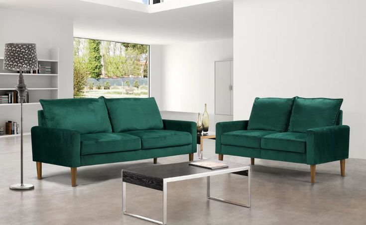 a living room with two green couches and a coffee table