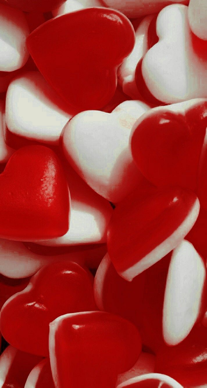 red and white heart shaped candies are piled on top of each other