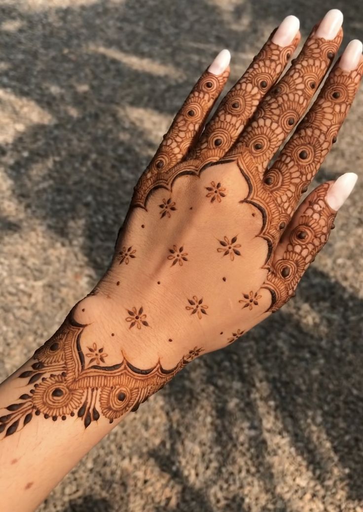 a woman's hand with hennap on it, showing the intricate design