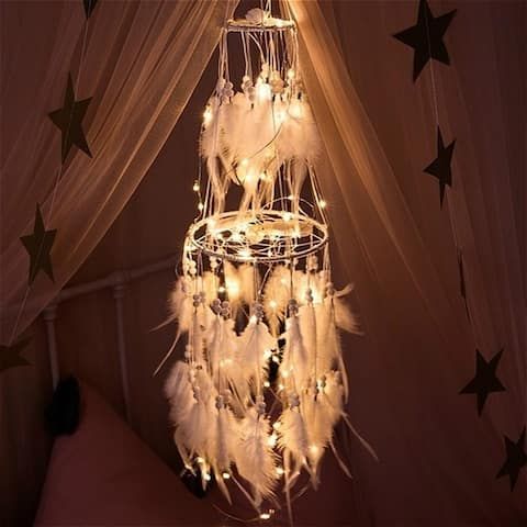 a chandelier hanging from the ceiling in a bedroom with stars on the walls