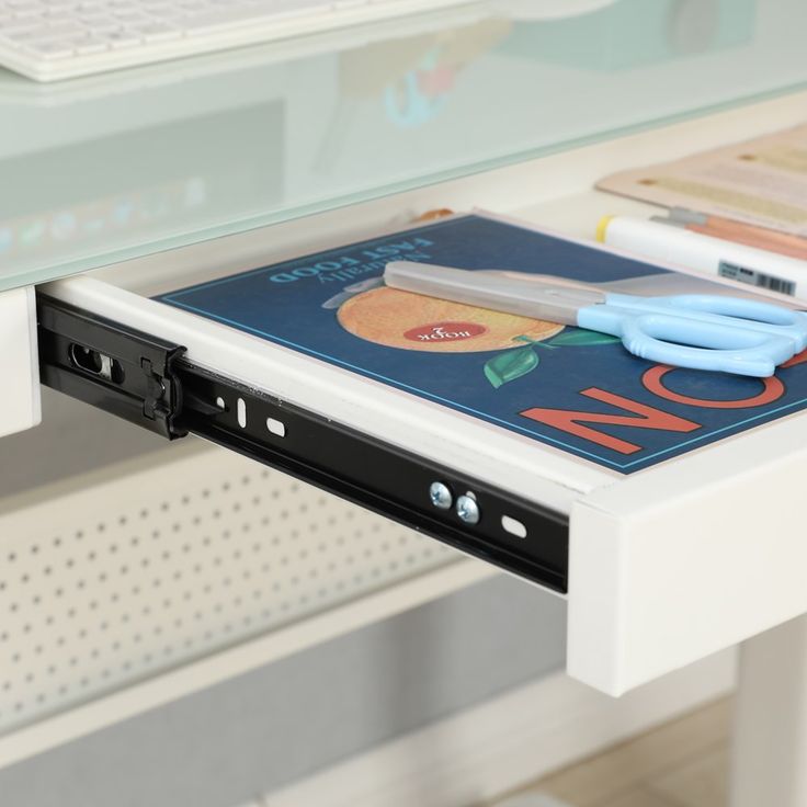 a laptop computer sitting on top of a white desk