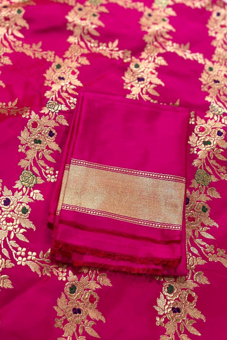 This exquisite handwoven banarasi katan silk saree in luxurious shade of pink with woven floral motifs, called jangla is nothing but regal. Traditional gold zari woven floral borders are highlighted with diya and lattice motifs. The pallu mirrors the borders, richly woven in gold zari. Approximate Length 6.5 mtrs (inclusive of blouse length)Height - 46 - 52" Saree comes with fall, picot and tassels done. Blouse piece is cut. Approximate weight - 1.8 lbs Kindly Note : The colors you see on your d