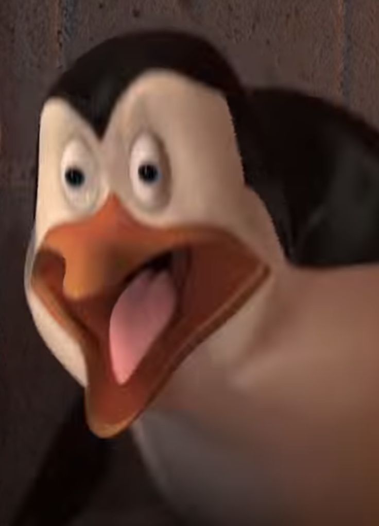 a close up of a cartoon penguin with its tongue out and his eyes wide open