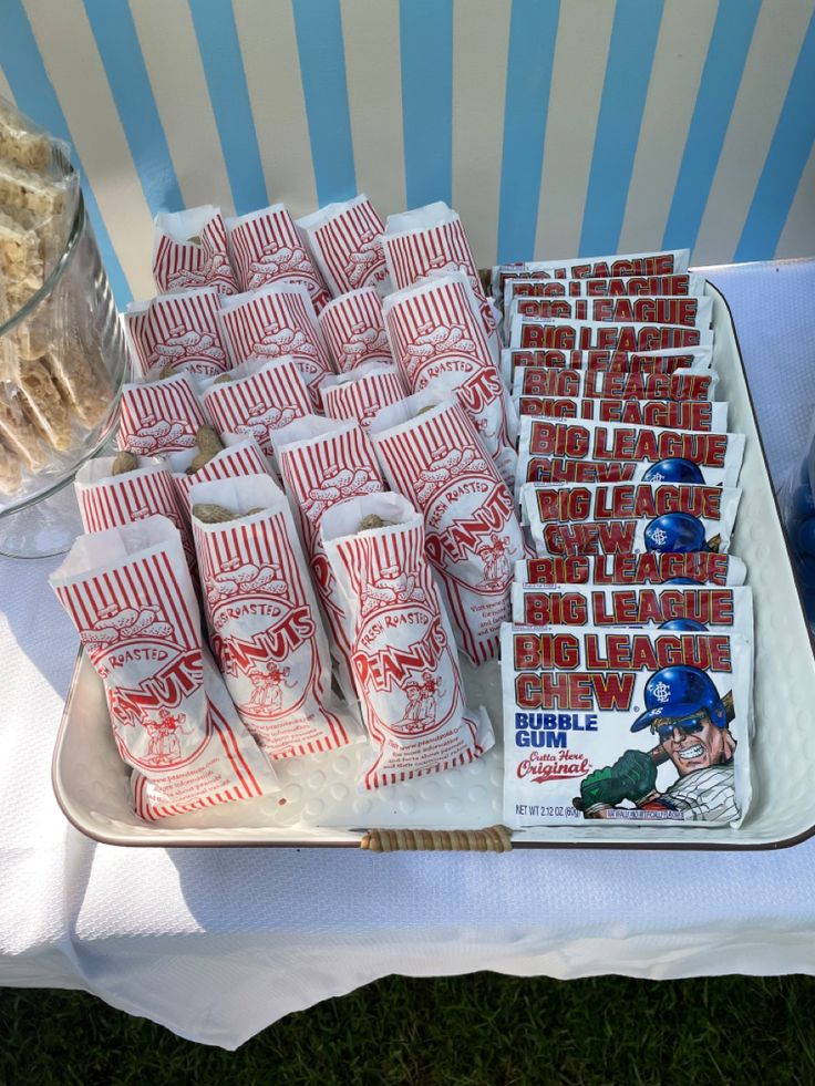 a table topped with lots of red and white candy bars on top of a plate