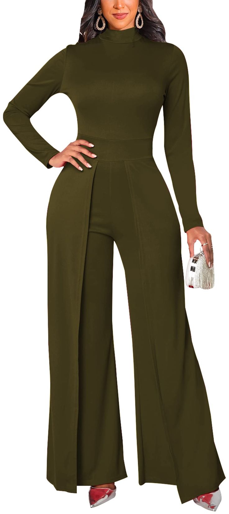 a woman in a green jumpsuit with her hands on her hips