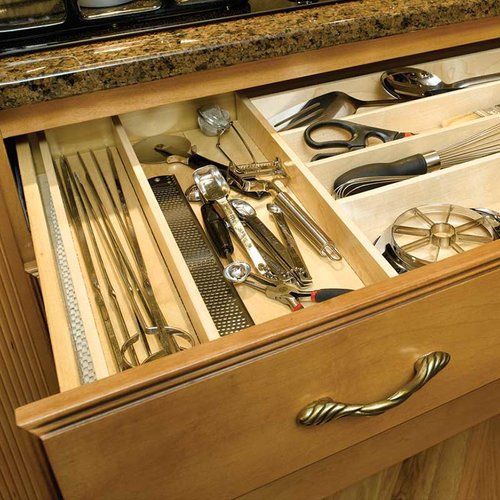 an open drawer with utensils in it