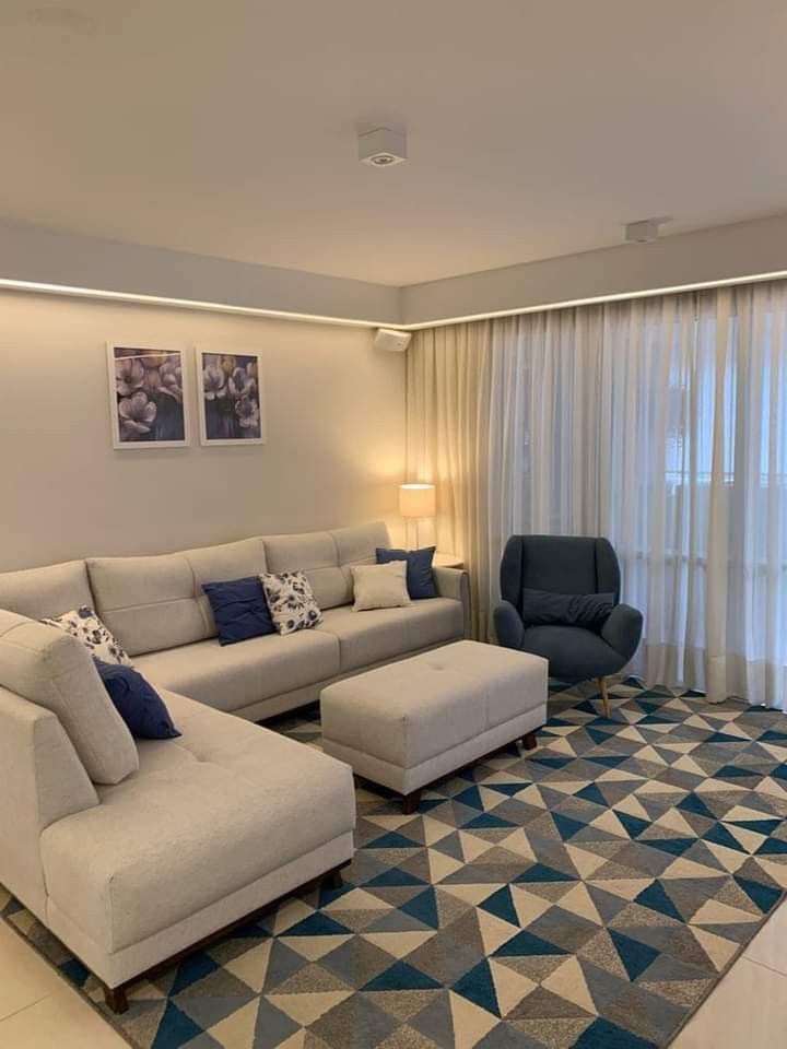 a living room filled with furniture next to a window