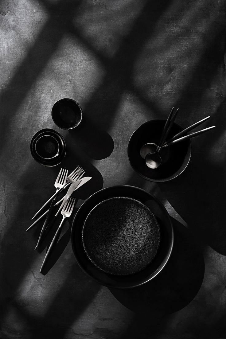 black and white photograph of table setting with utensils