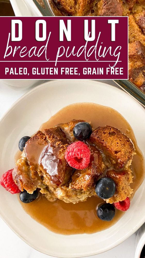 a white plate topped with french toast covered in gravy and berries next to a pan of bread pudding