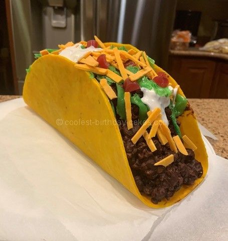 a taco with cheese, lettuce and other toppings