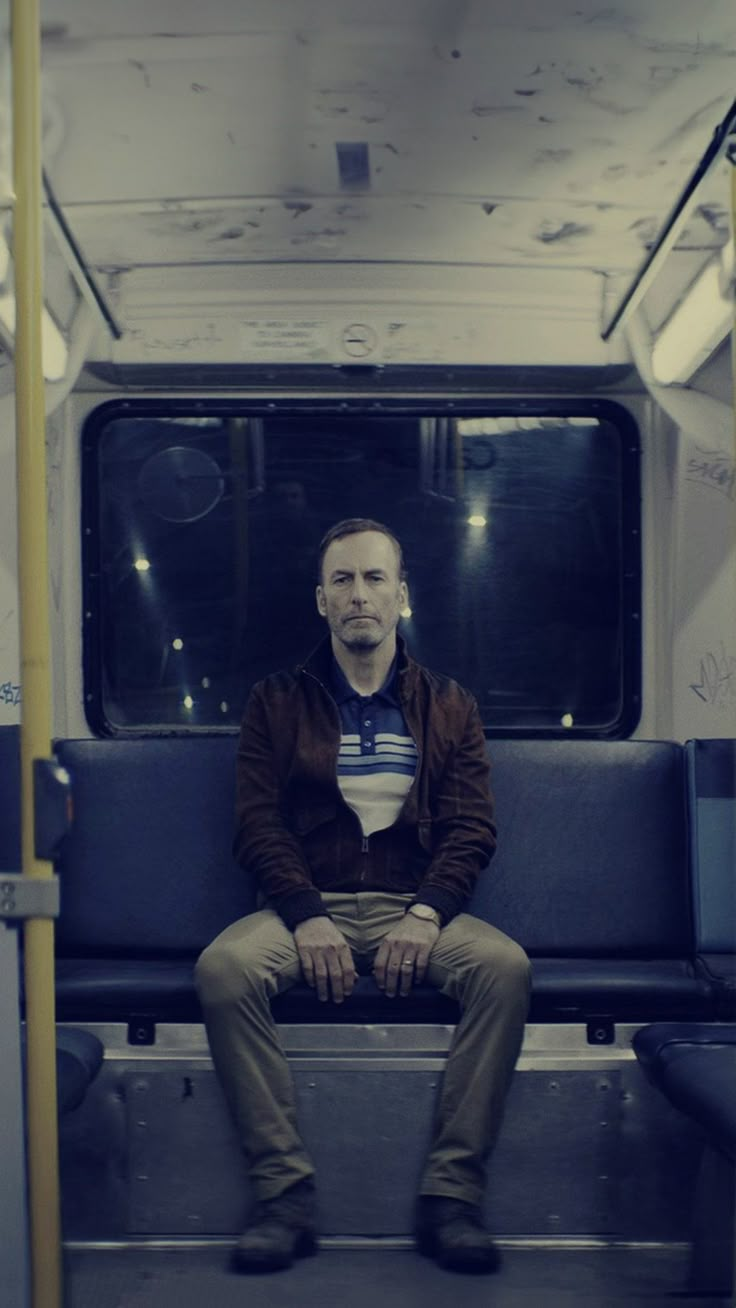 a man is sitting on a subway train