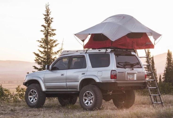 a truck with a tent attached to it's roof