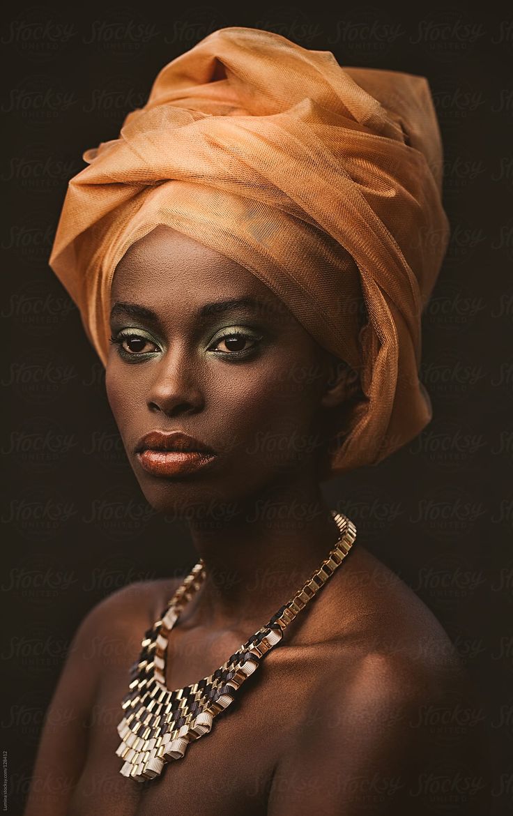 an african woman wearing a turban and necklace by jovan for stockstuffs