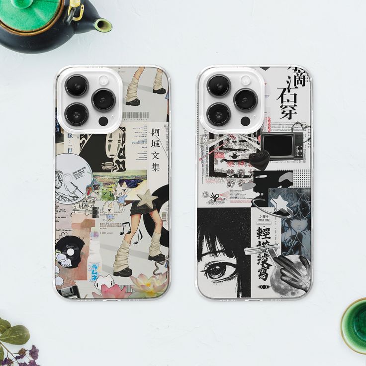 two cell phones sitting next to each other on top of a white table covered in pictures