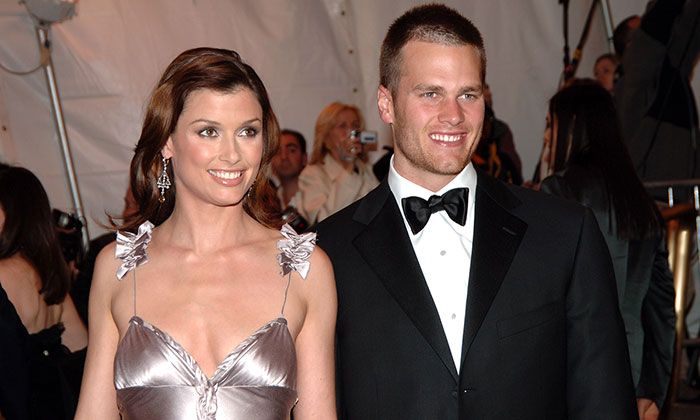 a man in a tuxedo standing next to a woman in a silver dress