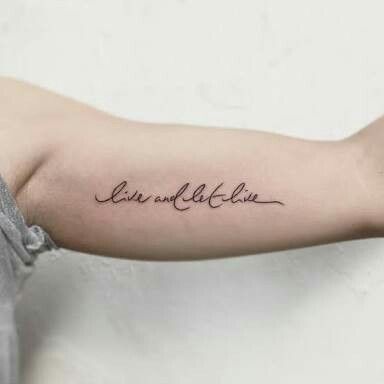 a person with a tattoo on their arm that says, love and life in cursive writing