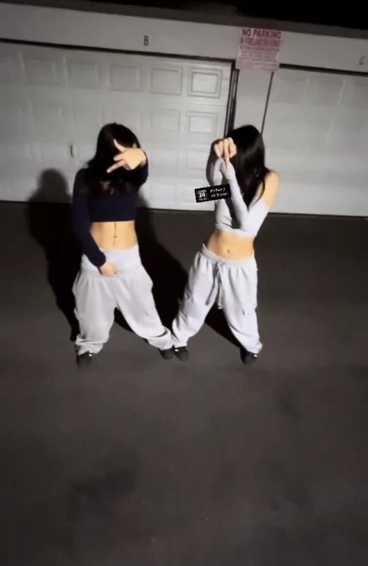 two women standing in front of a garage door