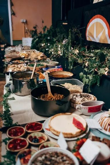 a buffet table filled with lots of food and desserts on it's sides