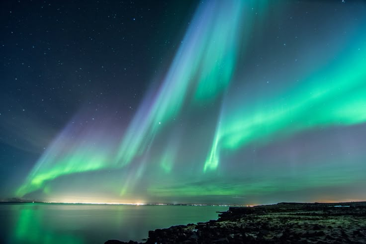 the aurora lights shine brightly in the night sky