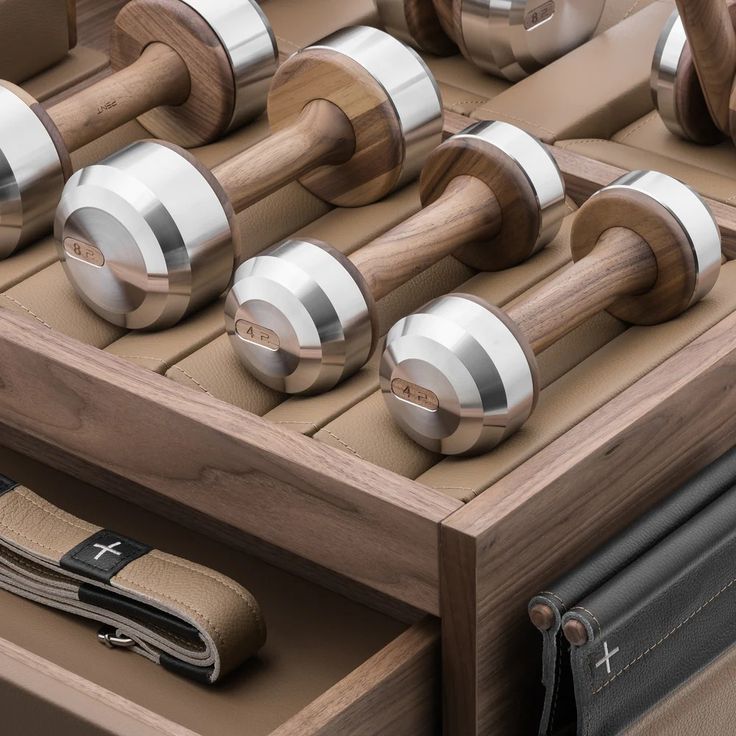 an assortment of wooden and metal knobs in a drawer