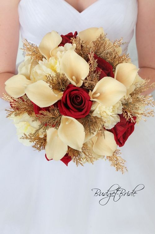 a bridal bouquet with red roses and white orchids is held by a bride