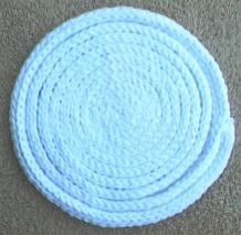 three white coasters sitting on top of a carpet