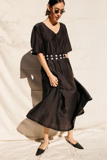 Inspired by an archival piece from the 1930s, the Ode Dress combines craft and technique into the perfect summer piece. Woven semi-sheer silk/cotton V-neck midi dress with an easy, blousy silhouette created through the intricate pleating around the waistline and sleeves. Waistband trimmed with glossy shell buttons - a Silk Pleated V-neck Maxi Dress, Summer Silk V-neck Dress For Work, Summer V-neck Silk Dress For Work, Pleated Silk V-neck Maxi Dress, Summer Silk Midi Dress With Pleated Waist, Bohemian Midi Dress For Spring Workwear, Silk Spring Dresses With Pleated Waist, Silk V-neck Midi Dress For Summer, Spring Silk Dress With Pleated Waist