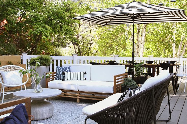 an outdoor patio with chairs, tables and umbrellas