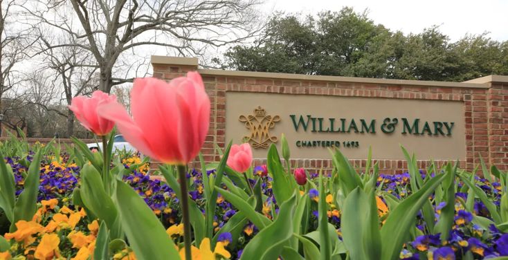 flowers are blooming in front of the sign for william and mary