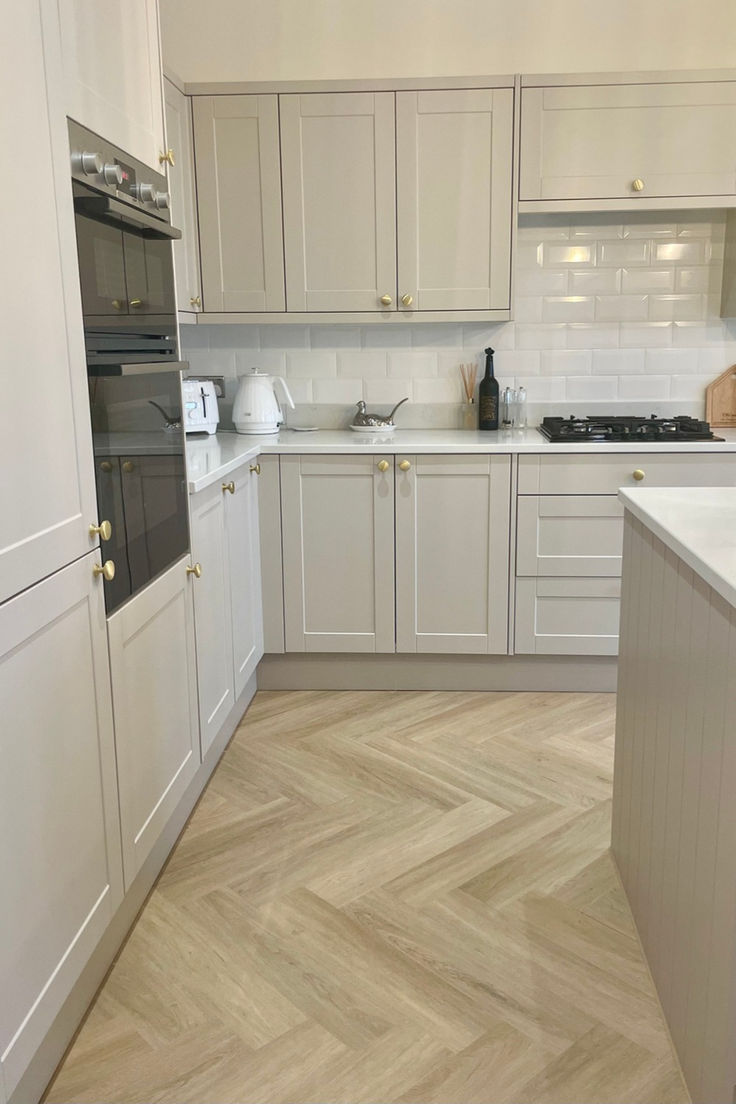 Happy couple standing in modern open plan kitchen 1930s House Renovation Kitchen, Terrace House Kitchen Ideas, Herringbone Floor In Kitchen, Kitchen And Hallway Flooring, 1930s House Kitchen, Kitchen Flooring Ideas Herringbone, Kitchen Ideas Herringbone Floor, Herringbone Kitchen Flooring, Herringbone Floor Lounge