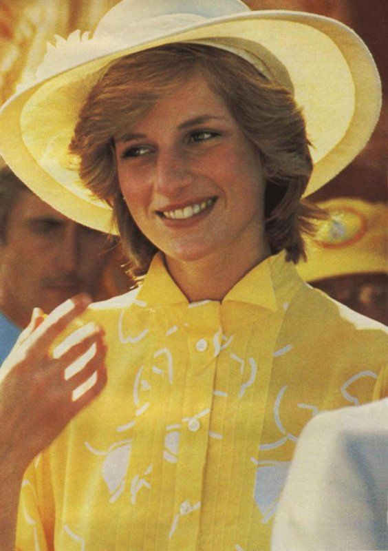 a woman wearing a yellow shirt and white hat