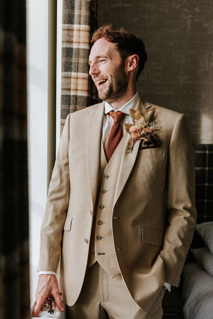 Bearded groom in beige three piece suit with orange tie and dried flower boutonnière for autumn wedding at Holmes Mill wedding venue Suit With Orange Tie, Groom Suit Summer, Beige Suits Wedding, Fall Wedding Suits, Fall Groom, Best Suits For Men, Beige Suit, Orange Suit, One Shoulder Bridesmaid Dresses