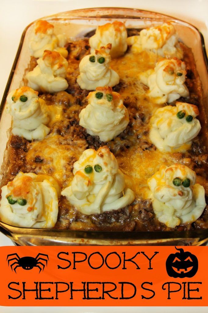 a casserole dish filled with meat, cheese and green onions in a spooky shepherd's pie