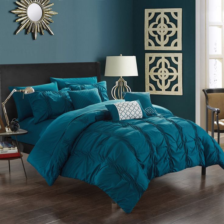 a teal colored bed in a bedroom