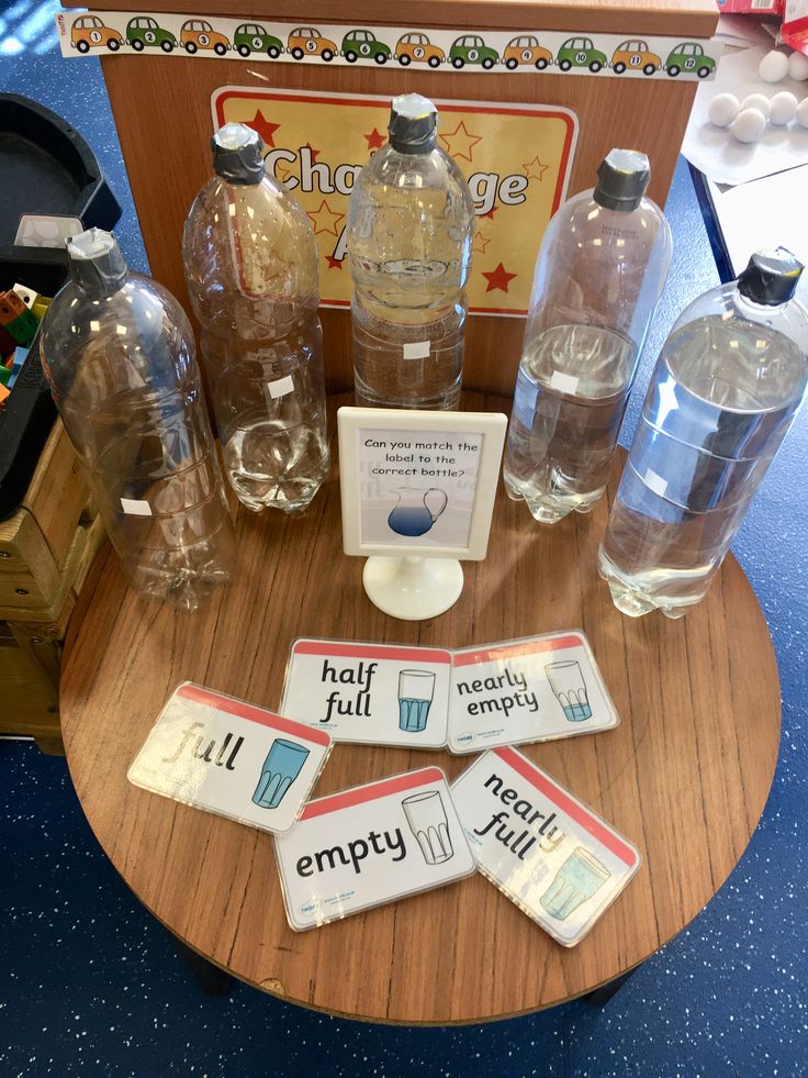 an assortment of water bottles and magnets on a table